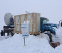 A Doppler-on-Wheels radar unit operates from a remote mountaintop location, requiring a lot of shoveling.